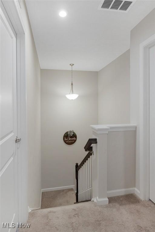 stairs featuring carpet, visible vents, and baseboards