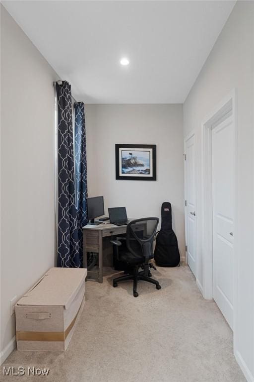 office area featuring light colored carpet and baseboards