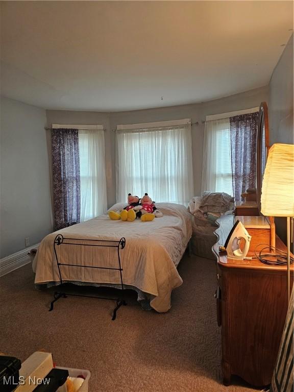 carpeted bedroom featuring baseboards