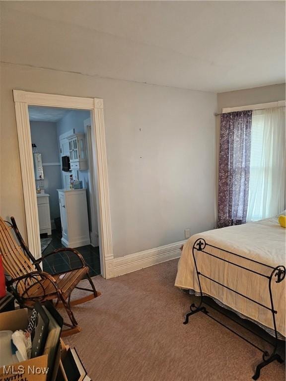 carpeted bedroom featuring baseboards