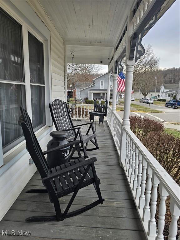 wooden terrace with a porch and a residential view