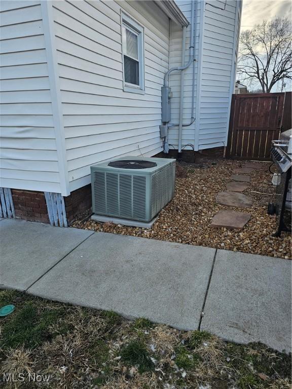 exterior space featuring cooling unit and fence