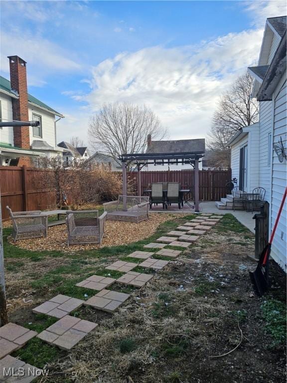 view of yard with a patio area, a fenced backyard, a gazebo, and a pergola