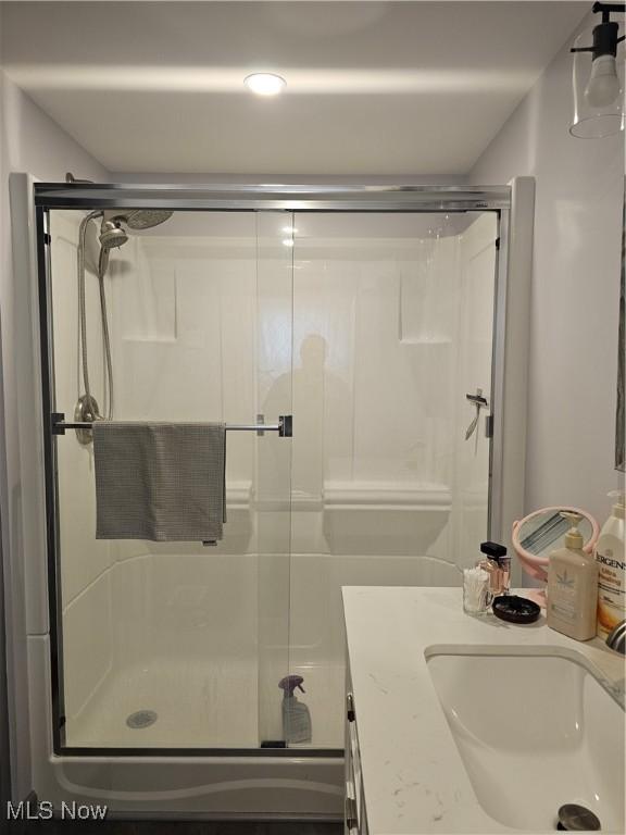 bathroom featuring vanity and a shower with shower door