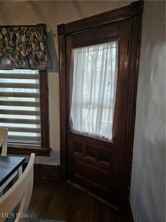 doorway to outside with dark wood finished floors