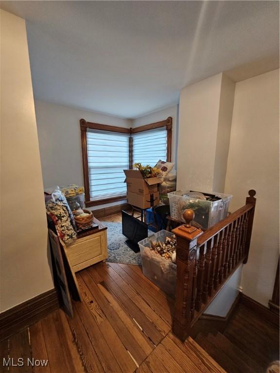 living room with baseboards and wood finished floors