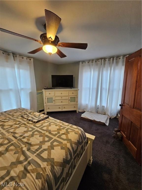 bedroom with dark carpet and ceiling fan