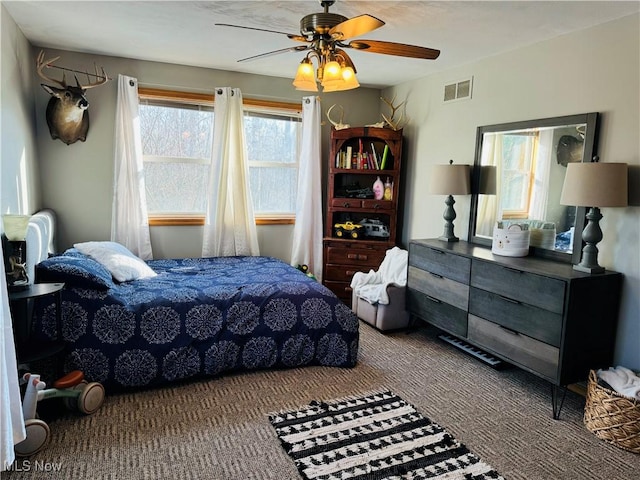 bedroom with ceiling fan, multiple windows, and visible vents