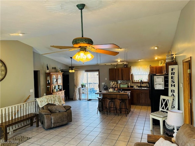 living room with lofted ceiling and light tile patterned floors