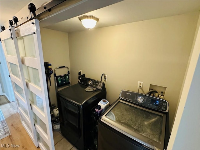 laundry room with laundry area and washing machine and clothes dryer