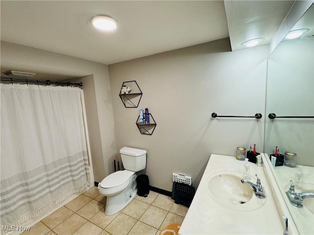 bathroom with toilet, vanity, baseboards, visible vents, and tile patterned floors