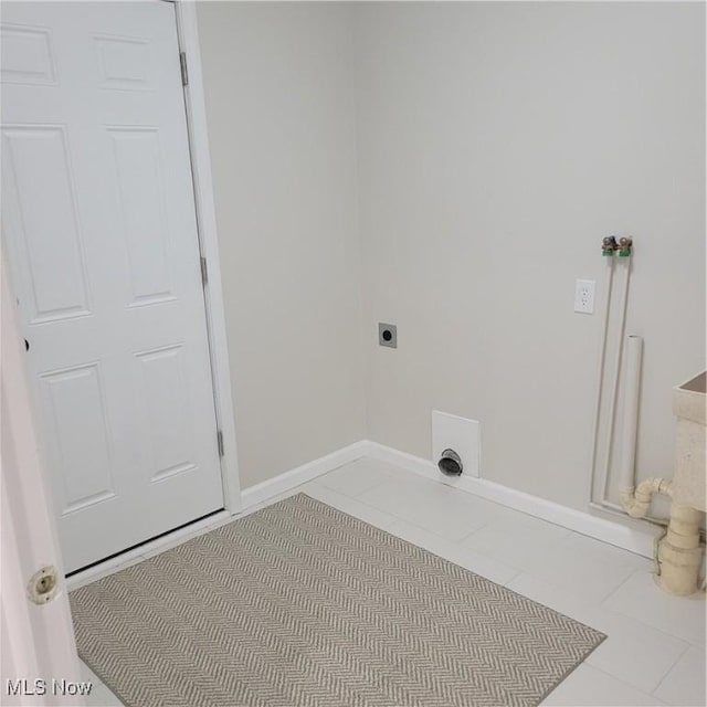 washroom with laundry area, electric dryer hookup, baseboards, and light tile patterned floors