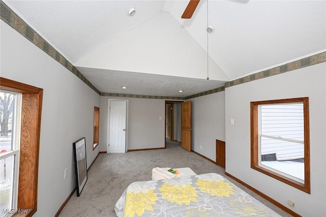 unfurnished bedroom featuring baseboards, high vaulted ceiling, ceiling fan, and light colored carpet