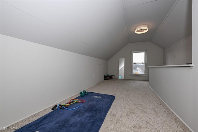 additional living space featuring lofted ceiling and carpet