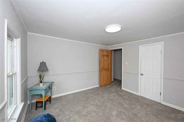 interior space featuring crown molding, baseboards, and carpet flooring