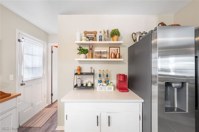 28628 Aspen Dr, North Olmsted, OH 44070 - kitchen featuring stainless steel fridge, white cabinets, open shelves, light countertops, and wood finished floors
