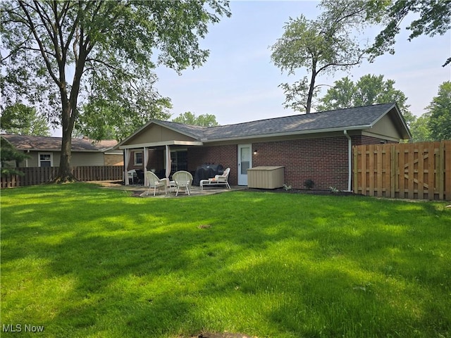 28628 Aspen Dr, North Olmsted, OH 44070 - rear view of house with a patio, brick siding, a fenced backyard, and roof with shingles