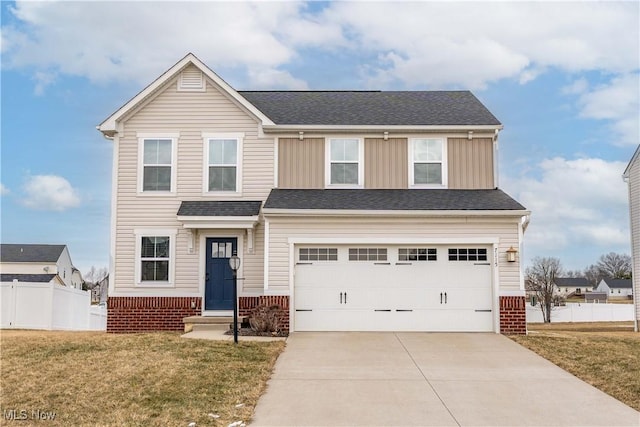 traditional-style home featuring brick siding, concrete driveway, an attached garage, fence, and a front yard