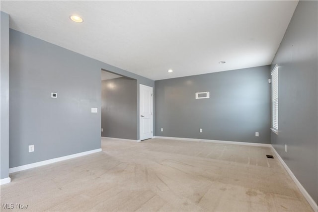 spare room with light carpet, baseboards, and recessed lighting