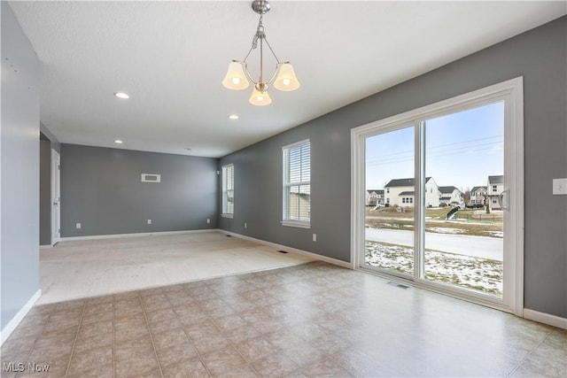 unfurnished room with recessed lighting, a notable chandelier, visible vents, baseboards, and a residential view