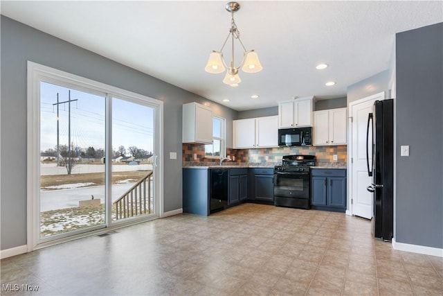 kitchen with decorative backsplash, decorative light fixtures, black appliances, white cabinetry, and a sink