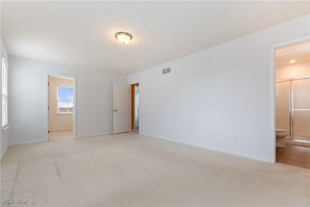 unfurnished room featuring light carpet, baseboards, and visible vents