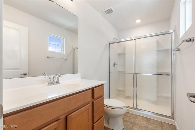 bathroom with toilet, a shower stall, visible vents, and vanity