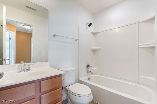 bathroom with visible vents, toilet, vanity, and washtub / shower combination