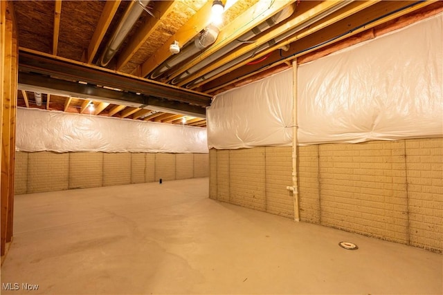 unfinished basement with brick wall