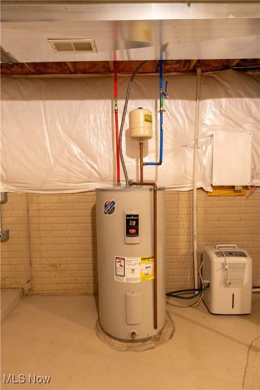 utility room with visible vents and electric water heater