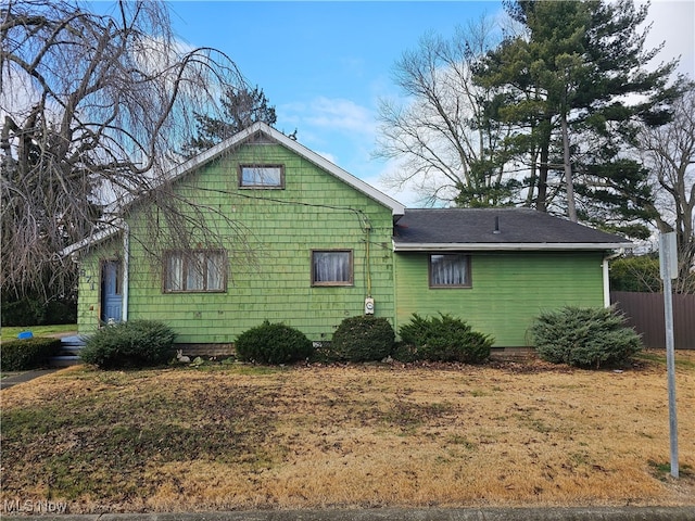 view of side of home featuring fence