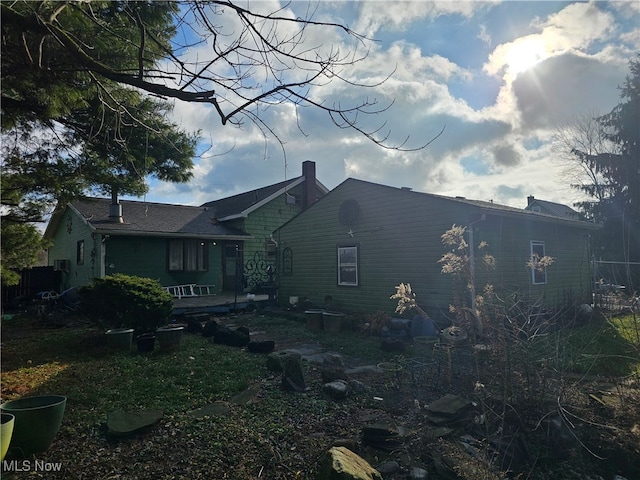 view of property exterior with a chimney