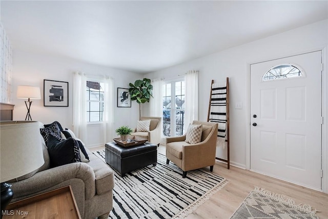 living area with light wood finished floors and baseboards