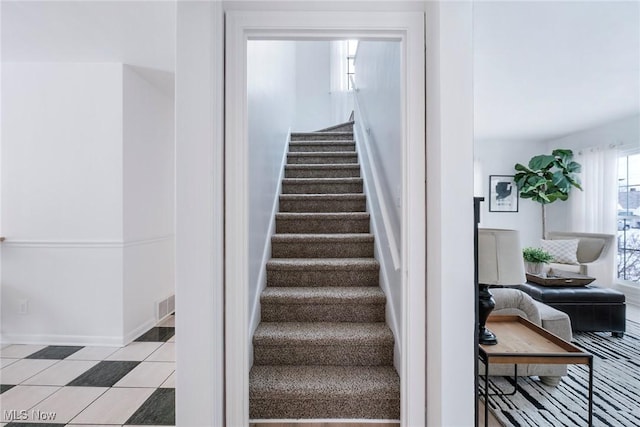 stairway featuring tile patterned flooring