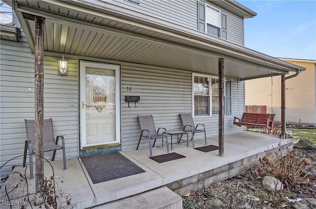 entrance to property featuring covered porch