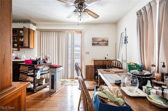 dining area with ceiling fan and wood finished floors