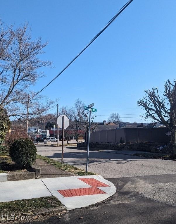 view of road featuring traffic signs and sidewalks