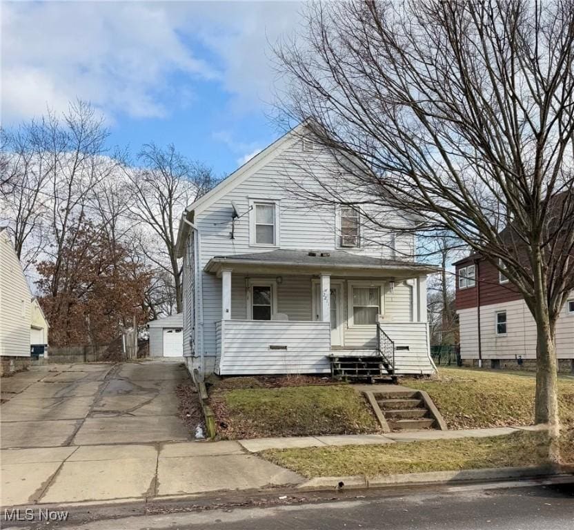 view of front of property featuring an outbuilding, a porch, and a garage