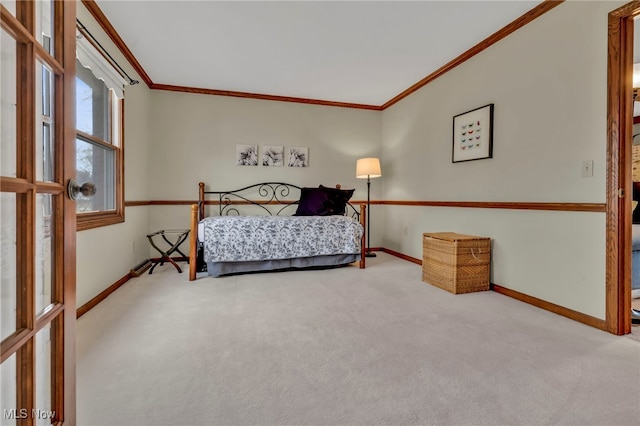 carpeted bedroom with crown molding and baseboards