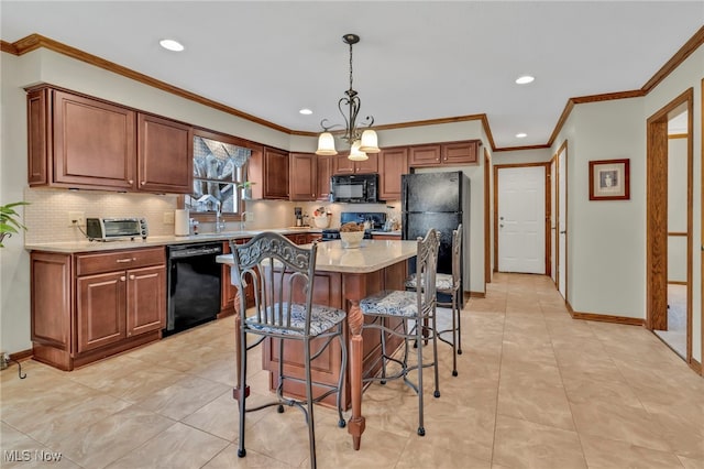 kitchen featuring a center island, decorative light fixtures, tasteful backsplash, black appliances, and baseboards