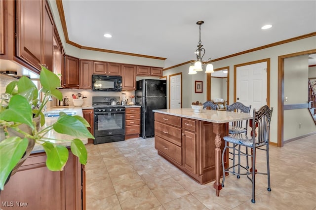 kitchen featuring brown cabinetry, a kitchen island, decorative light fixtures, light stone countertops, and black appliances