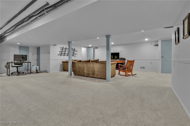 living area with baseboards, visible vents, and recessed lighting