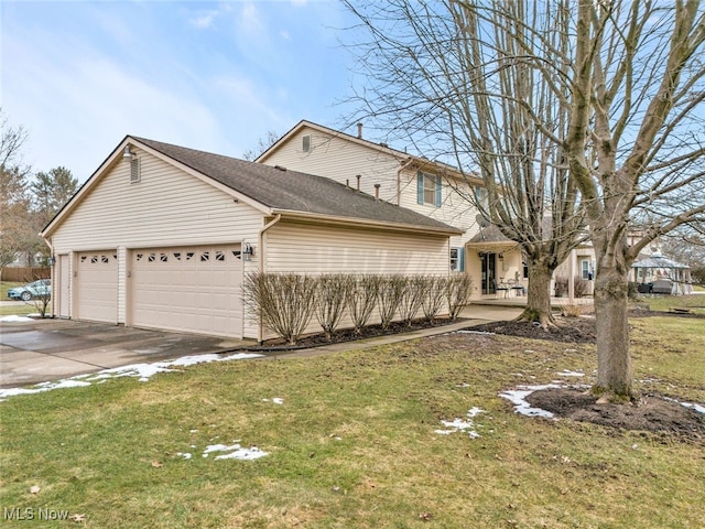 view of front facade with a garage, a front lawn, and aphalt driveway