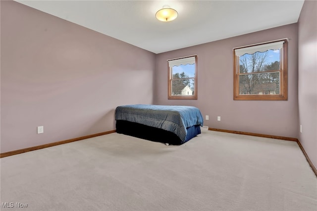 bedroom with carpet floors and baseboards