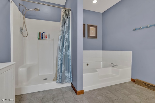 full bath featuring a shower stall, baseboards, and a bath