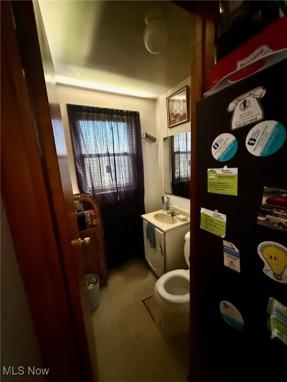 bathroom featuring tile patterned floors, a sink, and toilet