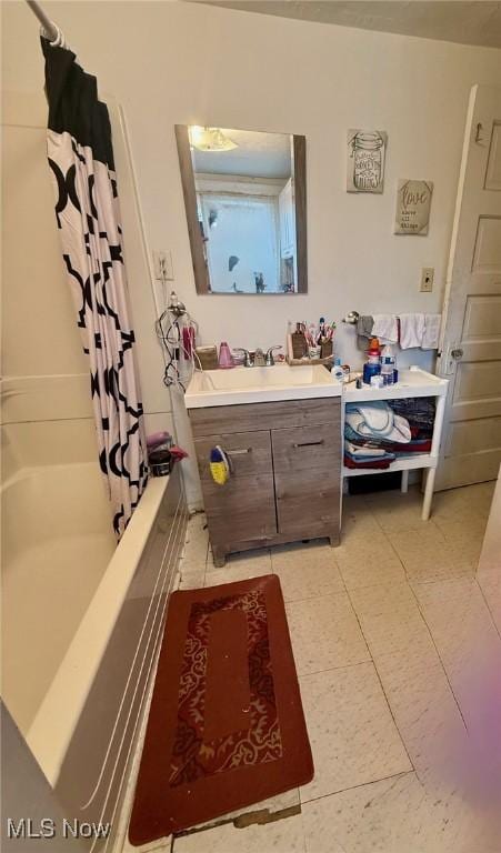 bathroom with vanity and shower / bath combination with curtain
