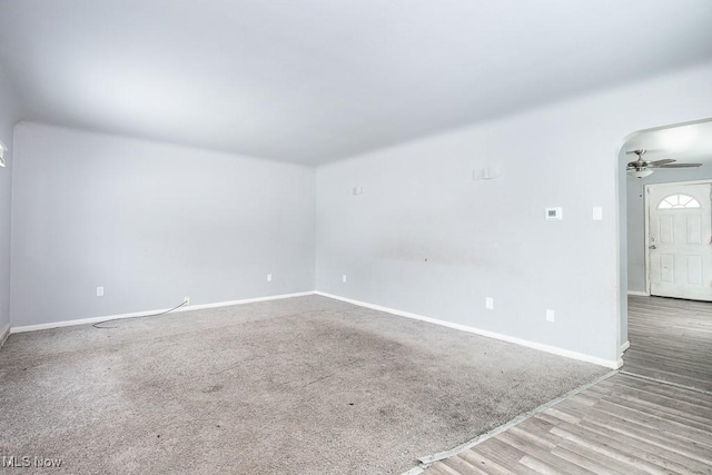 unfurnished room featuring light wood finished floors, baseboards, and a ceiling fan