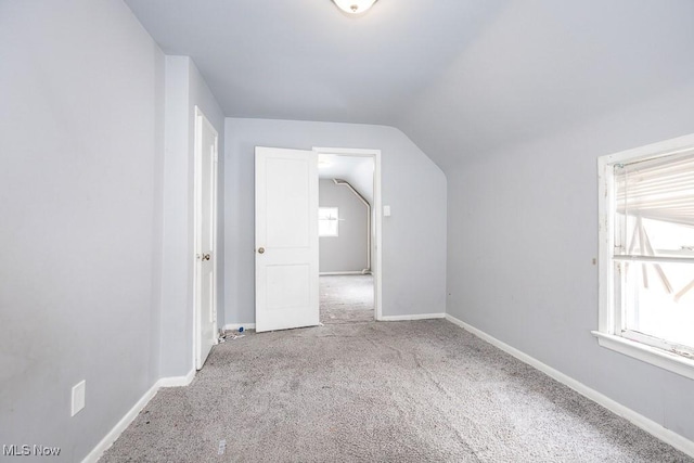 bonus room with vaulted ceiling, carpet flooring, and baseboards