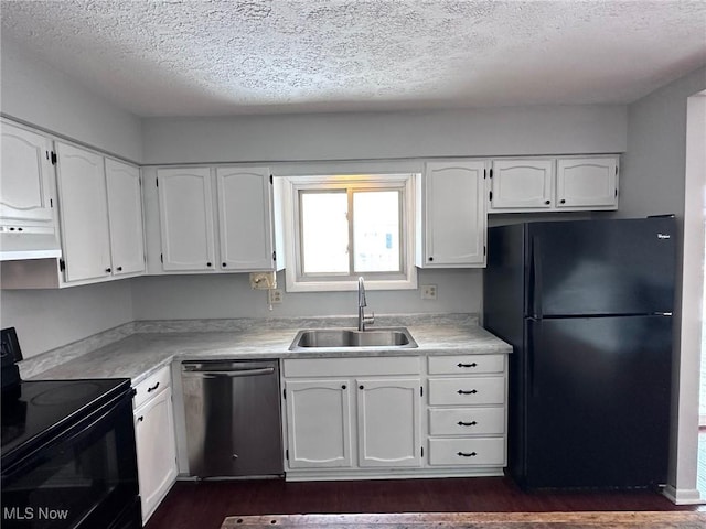 kitchen with black appliances, a sink, light countertops, and white cabinets